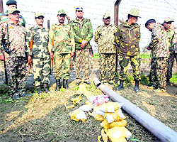 BSF officials with the seized contraband and fake currency in Amritsar
