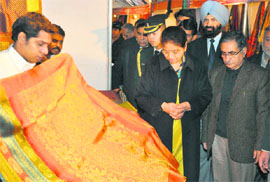 Usha Vohra takes a look at products on display after inaugurating the Silk Mark Expo at the Kala Kendra in Jammu on Wednesday.