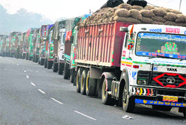 Trucks carrying essential commodities stranded on the Jammu-Srinagar national highway at Sidhra on Wednesday
