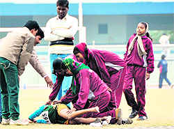 An athlete falls unconscious during the 3000 mt event on the opening day of the National School Games