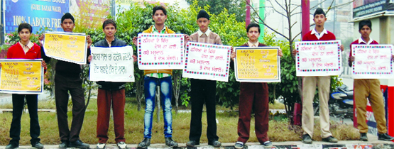 Schoolchildren stand with posters during a rally organised by the distric administration to make residents aware about their duties as voters in Amritsar on Thursday.