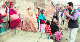 Karamjit Singh Rintu greets people during his poll campaign in Amritsar.