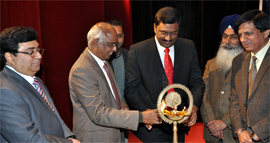 The dignitaries lighting the traditional lamp at the function on Thursday.