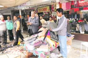 The enforcement wing of the MC removes encroachments from Krishna market, Sector 41, Chandigarh, on Thursday
