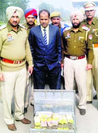 Police personnel with the cash recovered from a vehicle at the Dappar toll plaza in Dera Bassi on Thursday