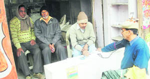 A doctor examines patients at a camp in Rewari.