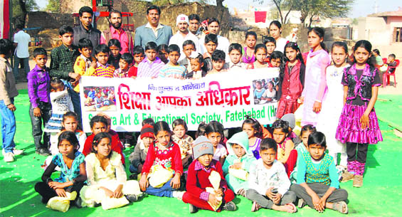 Schoolchildren, along with members of Savera Arts and Education Society, during an awareness programme at Bhuna in Fatehabad. 