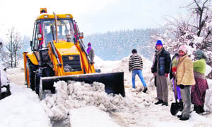 A snow cutter clears a road at Vashisht village near Manali on Thursday. 