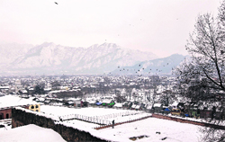 Srinagar under a white blanket after fresh snowfall on Thursday. Bad weather again led to the closure of the Jammu-Srinagar national highway. 