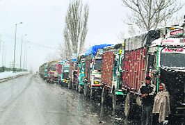 Trucks stranded at Qazigund following fresh snowfall in the Kashmir valley on Thursday.