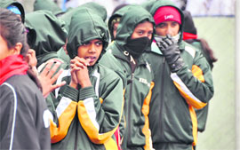 Athletes from Kerala brave the chill at the National School Games at Guru Nanak Stadium in Ludhiana.