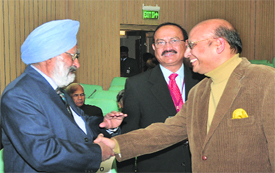 The Tribune Trustee Justice (retd) SS Sodhi (L) greets Congress spokesperson Abhishek Singhvi (R) while The Tribune Editor-in-Chief Raj Chengappa looks on. 