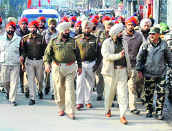 The police and paramilitary forces carry out a flag march in the Sultanwind area of Amritsar.