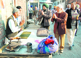 Amarjit Singh Asal (wearing green turban), candidate of the Sanjha Morcha from the Amritsar (West) constituency, during a door-to-door poll campaign in Amritsar.