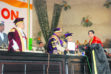 Governor Jagannath Pahadia awards a PhD degree to a scholar at the first convocation of Chaudhary Devi Lal University in Sirsa on Friday as Chief Minister Bhupinder Singh Hooda looks on. 