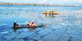 Girls row a boat on the Dal Lake on a sunny day in Srinagar on Friday.