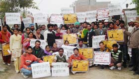 Members of the Nehru Yuva Kendra display posters during a voter awareness campaign held in the villages near Bathinda on Saturday