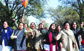 Workers of the BJP women wing raise slogans during a protest over the remarks against the party leader Uma Bharti, outside AICC headquarters in New Delhi on Saturday.