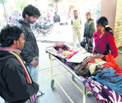 A patient waits in the corridor of Doon Hospital in Dehradun