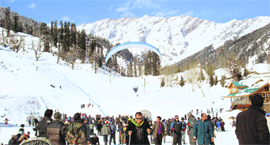 Tourists enjoy paragliding in the Solang valley, near Manali, on Saturday.