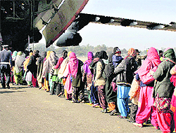 Stranded passengers queue up to board an Indian Air Force aircraft on Saturday