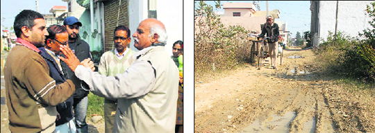 Congress activist Nalin Sharma (right) coaxes residents of Madhuban Colony as they complain about the sorry state of affairs in the area. (Right) Kutcha roads like this in Sangam Vihar have made residents lose trust in politicians. 