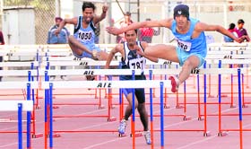 Players participate in a hurdle race in 57th National School Games at Guru Nanak Stadium in Ludhiana on Saturday