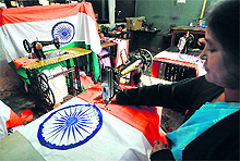 A woman stitches the Tricolour in a Guwahati workshop