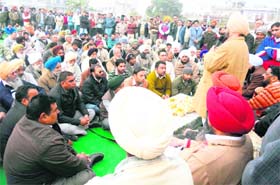 Congress candidate Lal Singh addresses an election rally in Sanaur