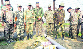 BSF officials with the seized contraband and fake currency in Amritsar.