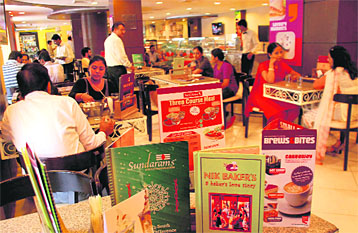 People have food at an Aroma eatery in Chandigarh.