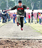 A boy participates in the long jump event during the Kids Olympics in Chandigarh on Sunday.