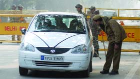 In view of the Republic Day Parade, police officials search a car at Mansingh Road, New Delhi, on Sunday