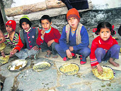 Children enjoy food at Bikol village in Dhanaulti.