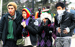 Tourists cover themselves in woollens as the temperature dips in Shimla on Sunday