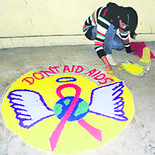 A student participates in a rangoli competition during an AIDS awareness camp at the agriculture university in Palampur on Sunday