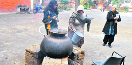 A Kerala athlete being given warm water at Khalsa Girls Senior Secondary School in Ludhiana.