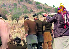 A Taliban militant shoots and kills Pakistani soldiers in this still from a video obtained by Reuters