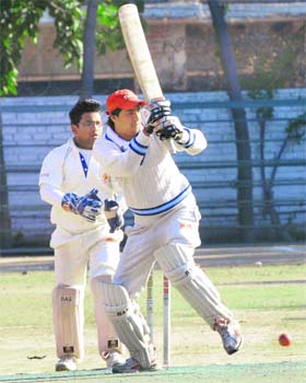 A player plays a shot during a match of Sardar Bhagwant Singh Memorial Cricket tournament