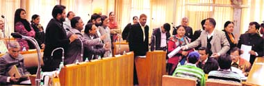 Pawan Kumar Bansal (extreme left) reads MC regulations while BJP councillor Arun Sood shows MC Act provisions to Congress councillors during the first General House of the municipal corporation in Chandigarh on Monday