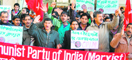 Activists of the CPM raise slogans outside the PWD office in Shimla on Monday.