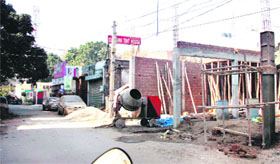 A commercial building being raised on a road in Model Town near Police Division No.6, even as the area has not been declared commercial, in Jalandhar on Monday.