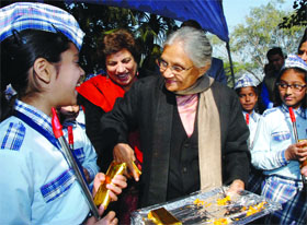 Chief Minister of Delhi Sheila Diskhit and women and child welfare minister Kiran Walia talk to girls at a function held to celebrate National Girls Child Day in New Delhi on Tuesdasy. 
