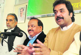 HJC chief Kuldeep Bishnoi underscores a point  at a press conference in Chandigarh on Tuesday as Haryana BJP in charge Harsh Vardhan and state BJP chief Krishan Pal Gurjar look on. 