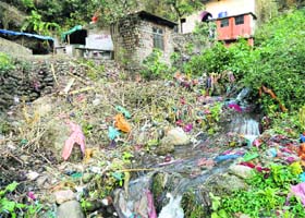 Clothes left by women lie scattered around the kund