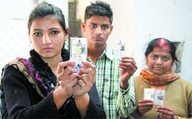 Residents of Arjun Nagar locality in Jalandhar show their faulty voter cards