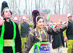 Kashmiri artistes perform during a full-dress rehearsal for the Republic Day parade at Bakshi Stadium in Srinagar on Tuesday