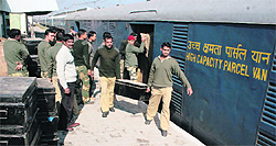 BSF jawans unload their luggage from a compartment at the Jammu railway station on Tuesday