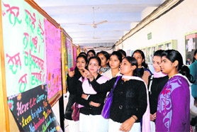 Students look at posters during National Voters Day celebration in Amritsar on Wednesday. 