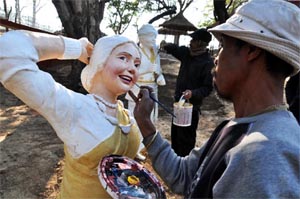 An artist from Assam gives the final touch to a statue for the Surajkund Crafts Mela, starting on Febuary 1 in Faridabad on Wednesday